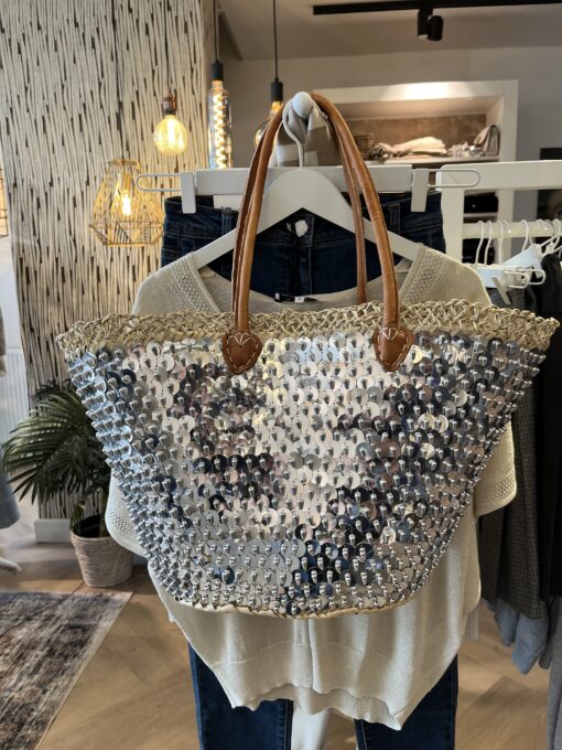 rieten strandtas zilver grote pailletten 39.95 Super gave rieten strandtas met grote zilveren pailletten. Onze Westmoodz collectie rieten strandtassen zijn handmade gevlochten tassen… de pailletten zijn er stuk voor stuk opgenaaid waardoor ze stevig vast zitten op het riet. De rieten strandtas is afgewerkt met extra lange hengsels, zodat deze makkelijk op de schouders kan worden gedragen. De hengsels zitten vast aan de tas met metalen spikes, waardoor het geen probleem is om lekker veel spullen/gewicht mee te nemen. Dat maakt ze heel handig en leuk als shopper…maar helemaal geweldig voor een dagje on the beach! De strandtas heeft een afsluitbare binnenvoering met tunnelkoord. Onze rieten strandtassen worden hand gemaakt in Marrakech. Het strandtas op de foto is model ibiza Model ibiza heeft een open gevlochten rietrand Ibiza BIG size 35cm hoog – 45cm breed